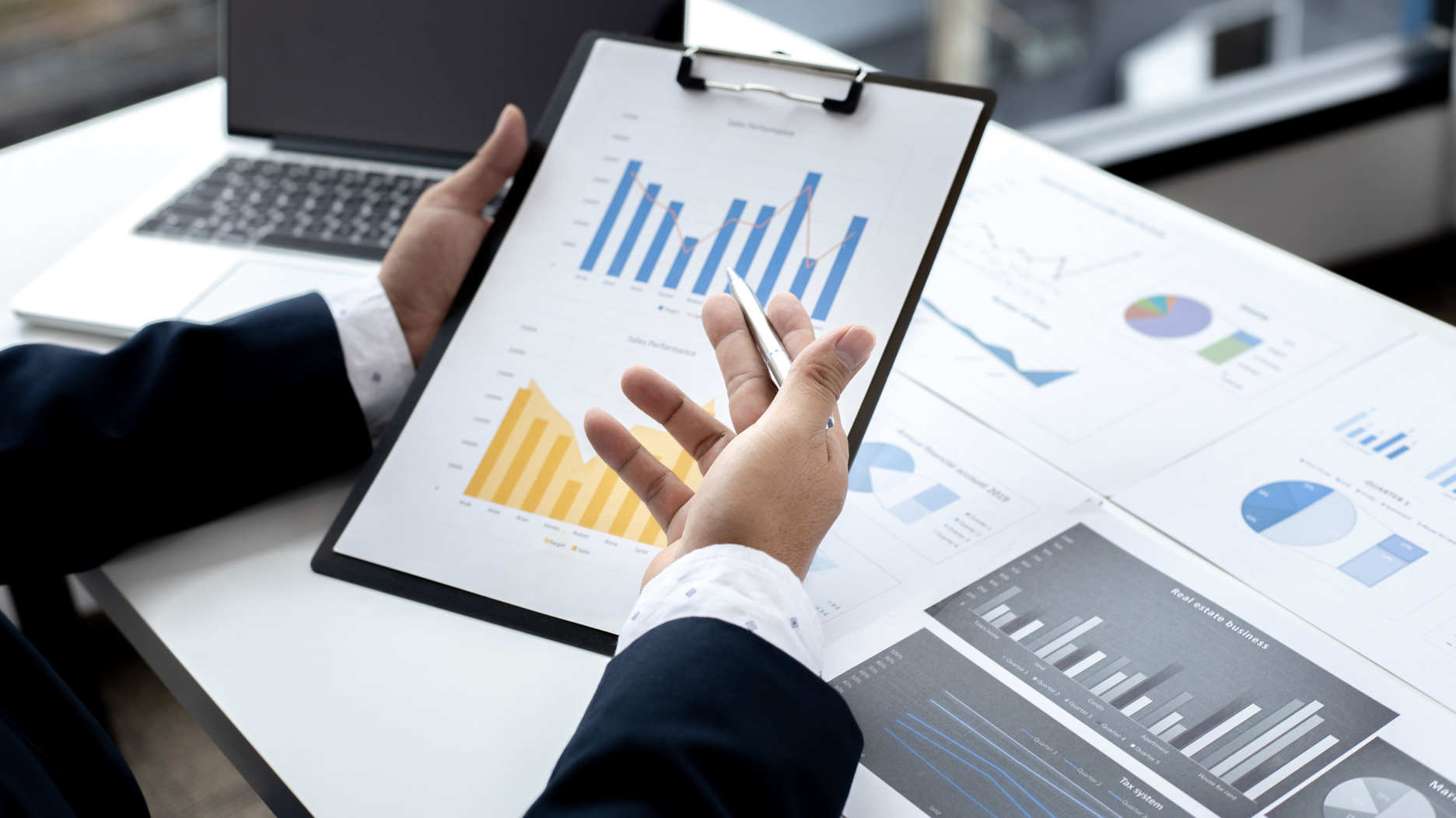 Man Looking at Financial Reports at the Office 
